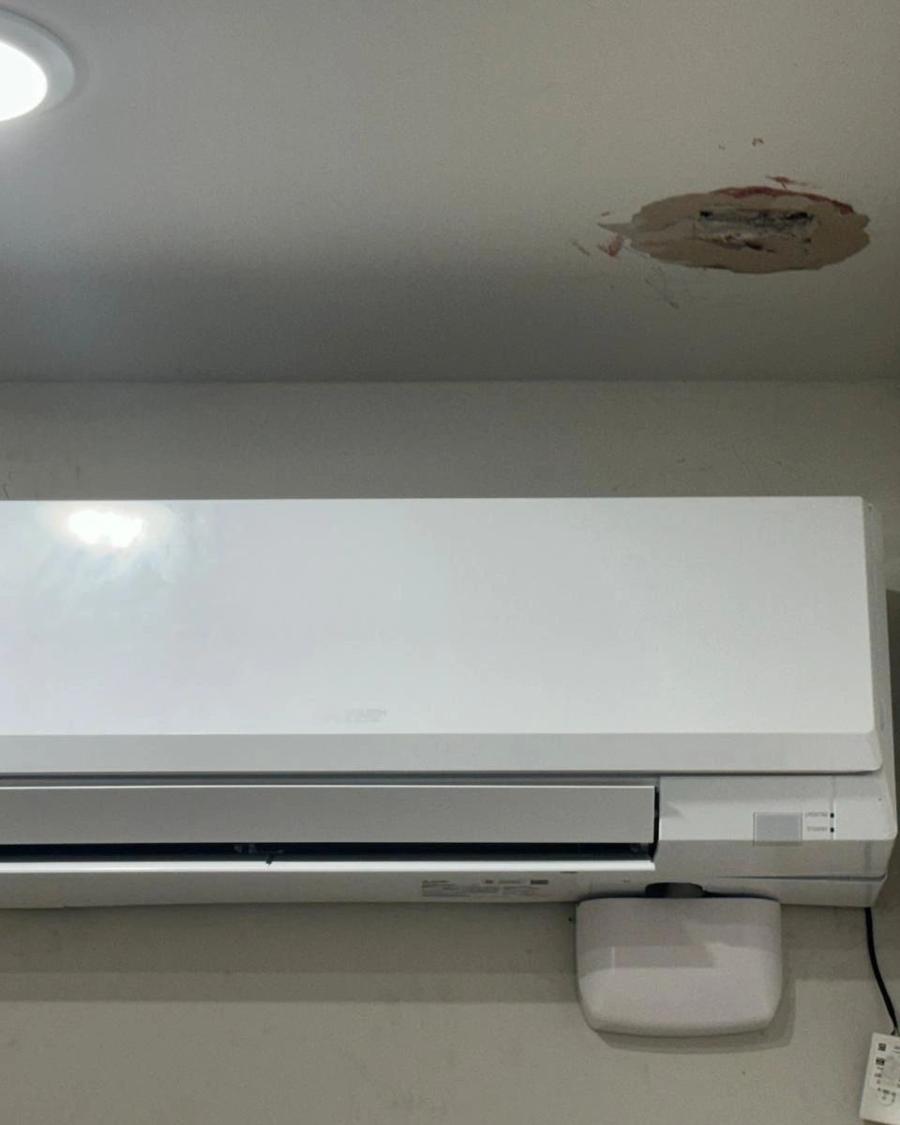 Ductless mini-split mounted on a bedroom wall